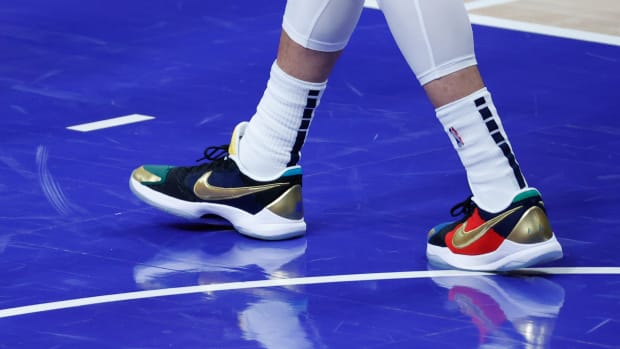 View of black, gold, and red Nike Kobe shoes.